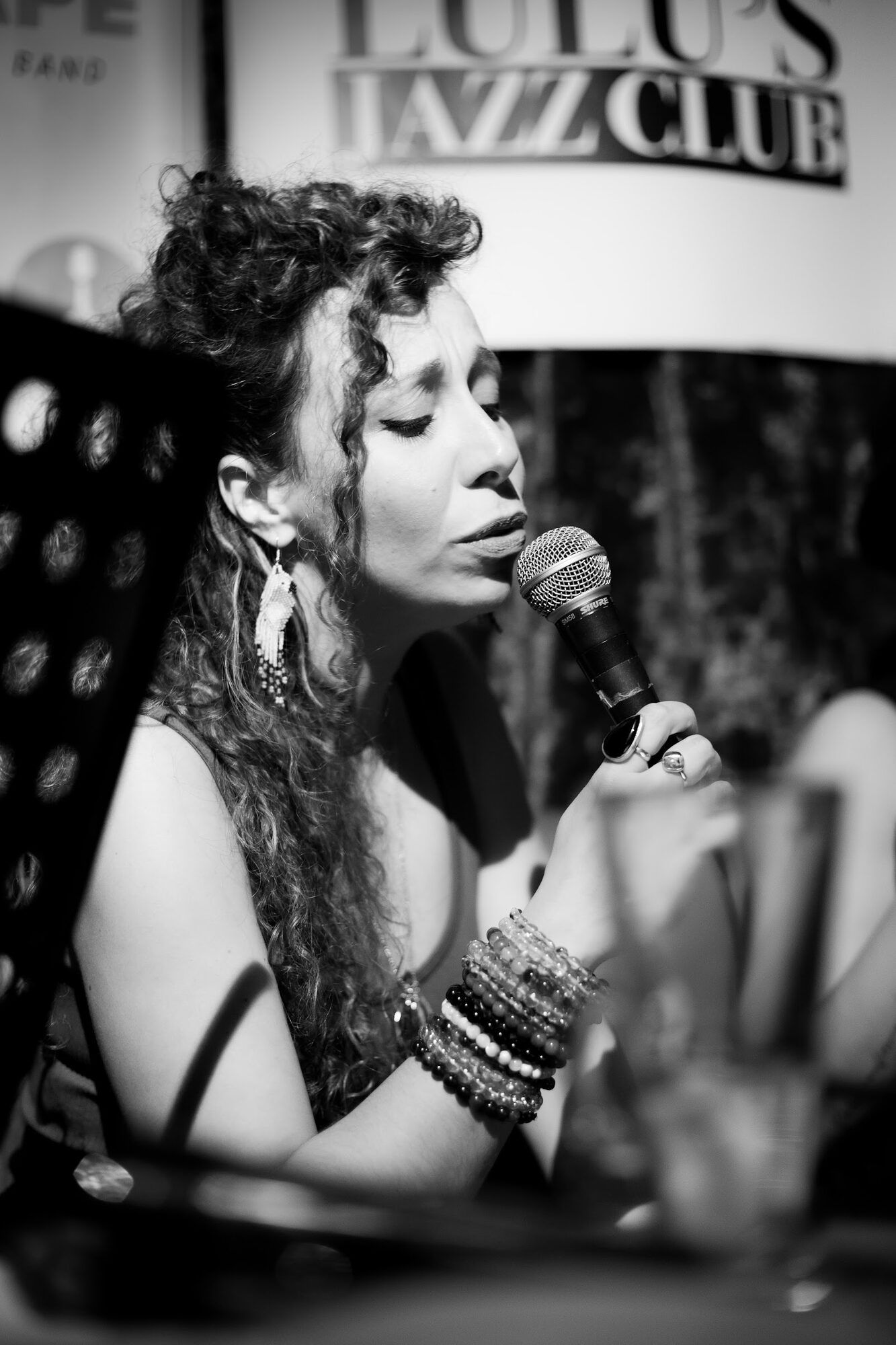 Black and white: a singer with a microphone in a jazz club
