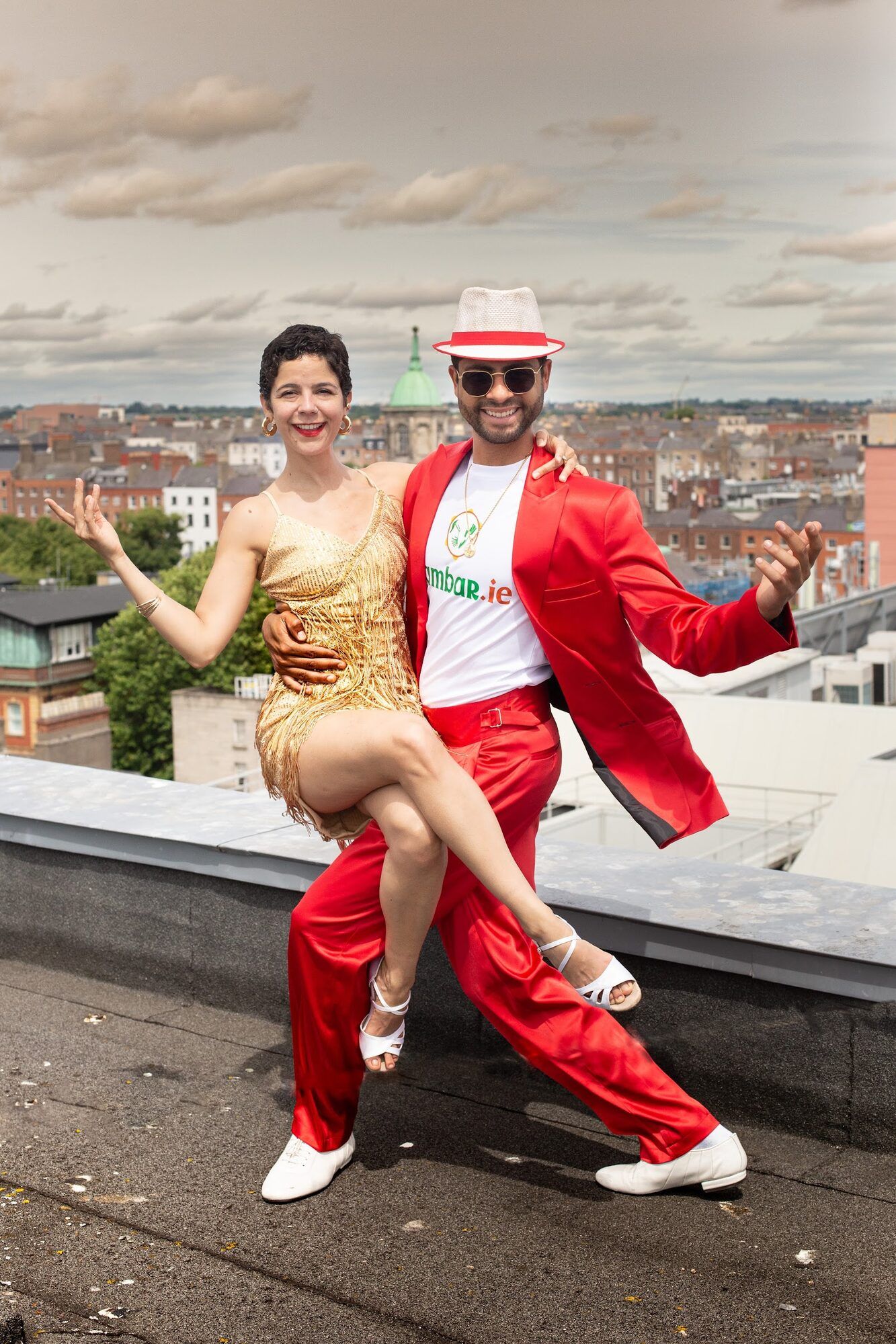 Two dancers mid-move on a rooftop