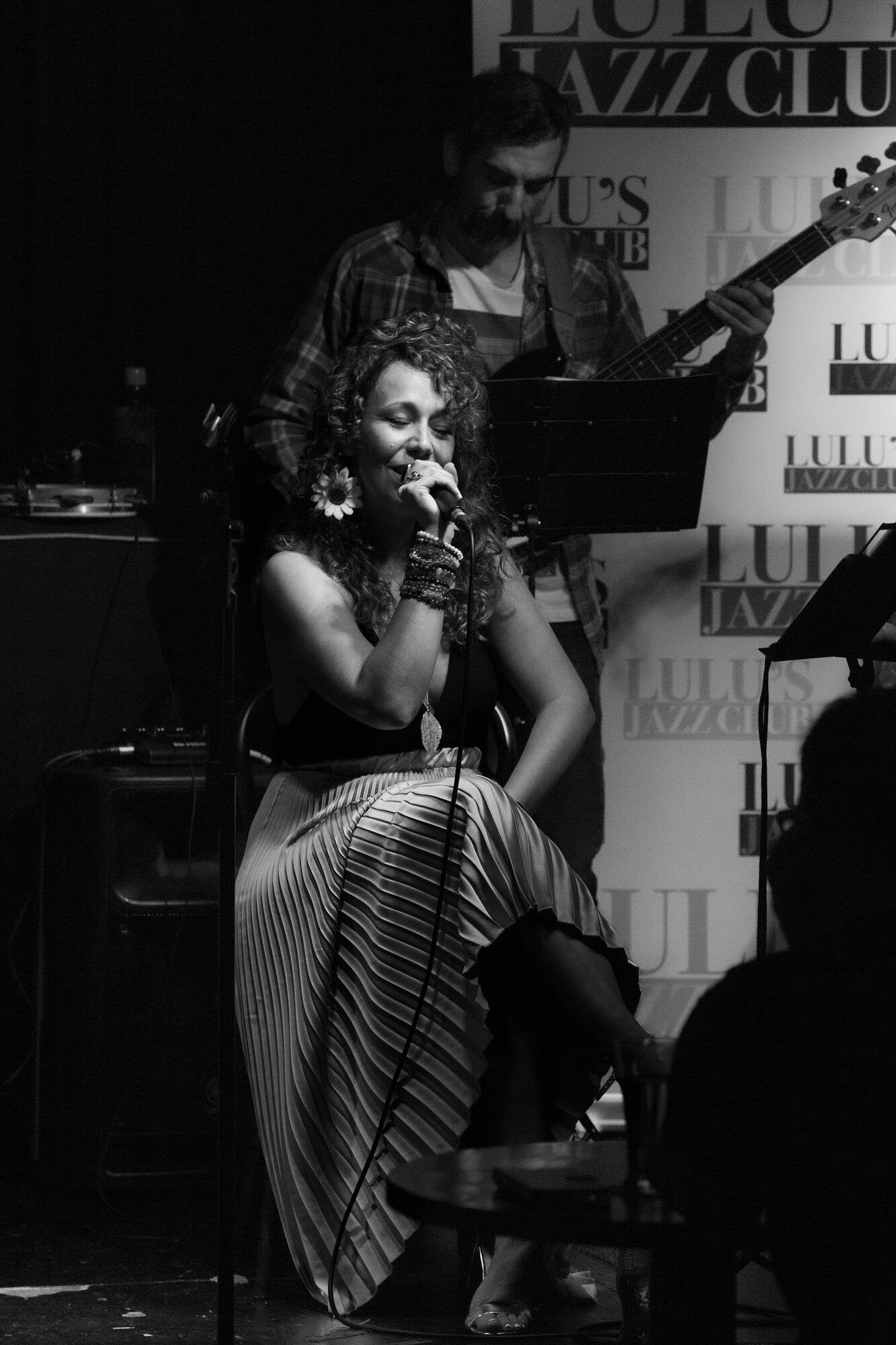 Black and white: a singer on stage with her band