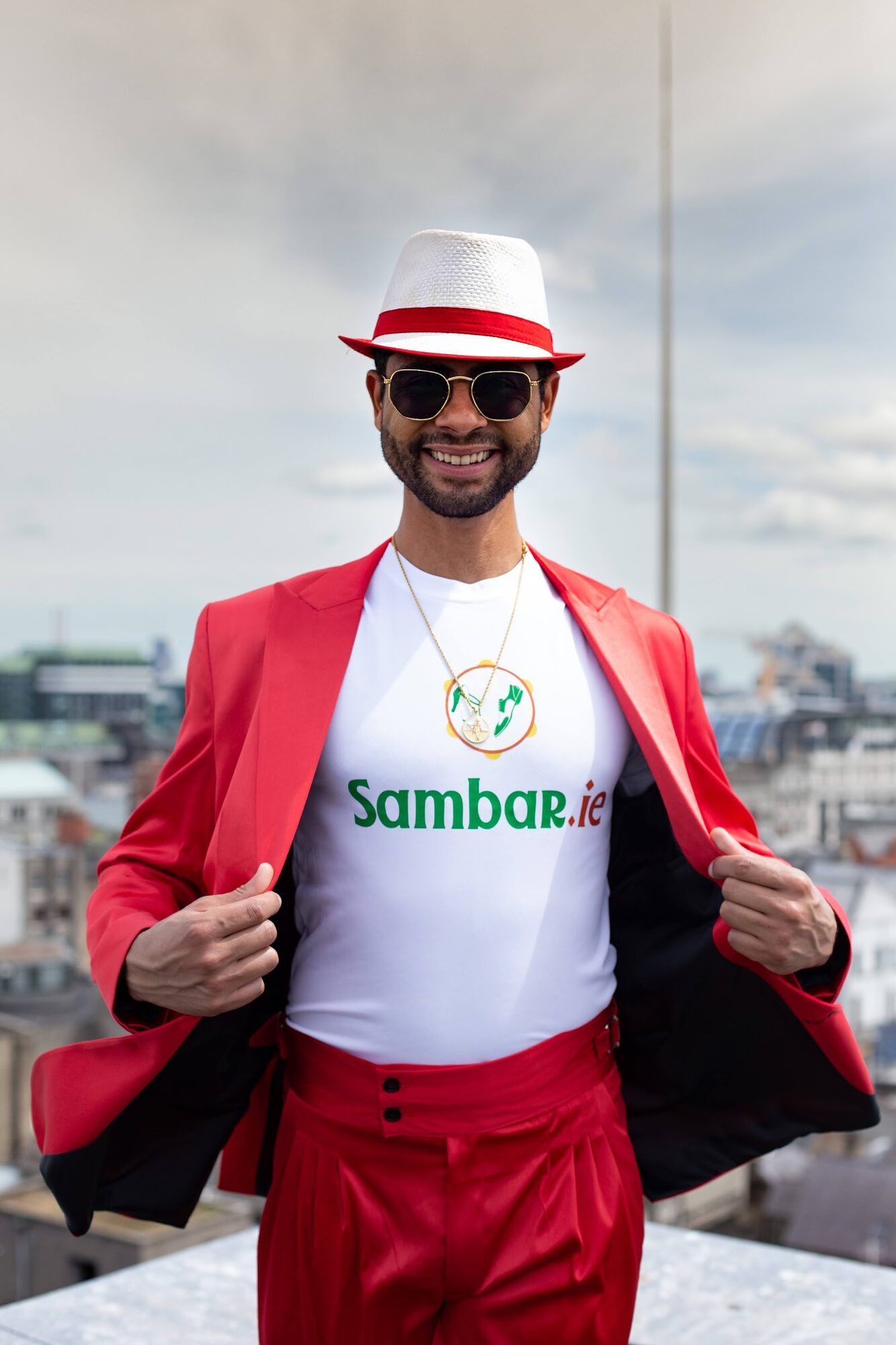 Man in a red jacket and white hat opening his jacket