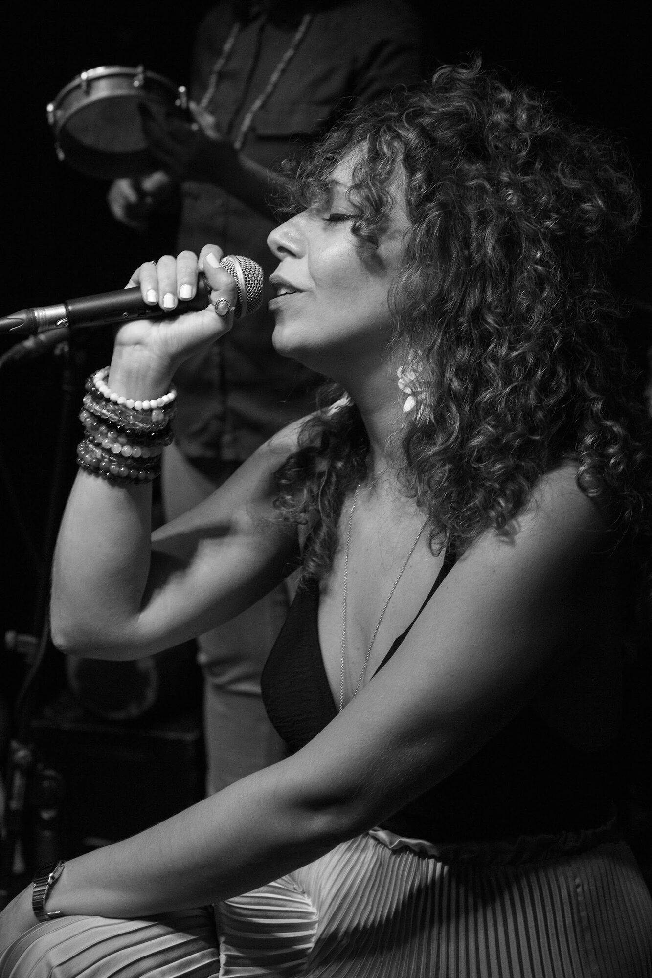 Black and white: a singer in profile at the microphone