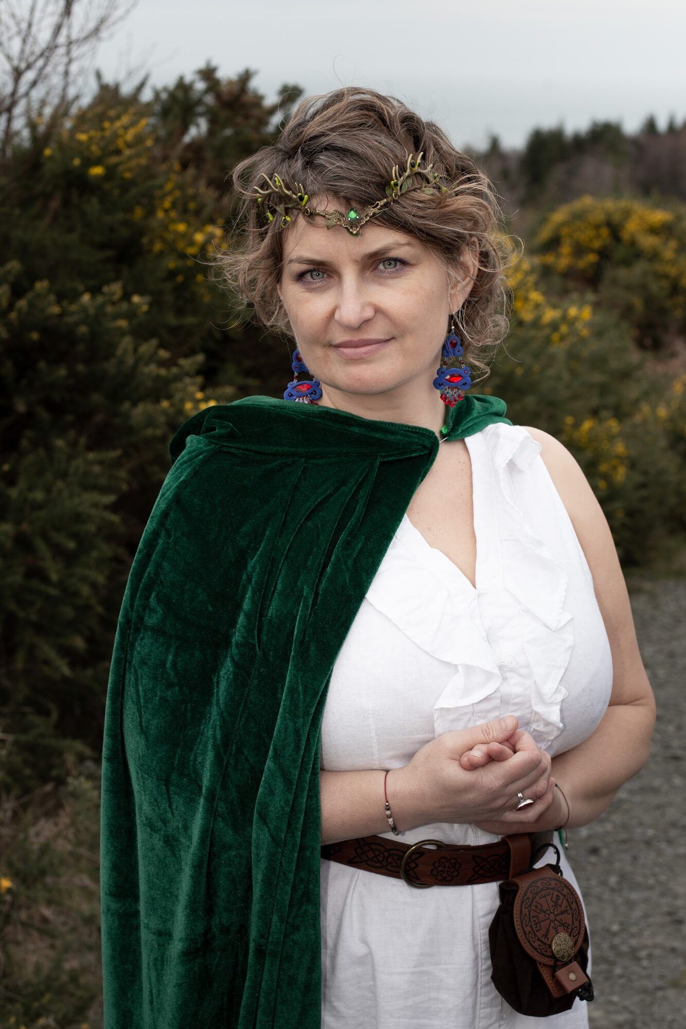 The same woman closer, green cloak and white dress