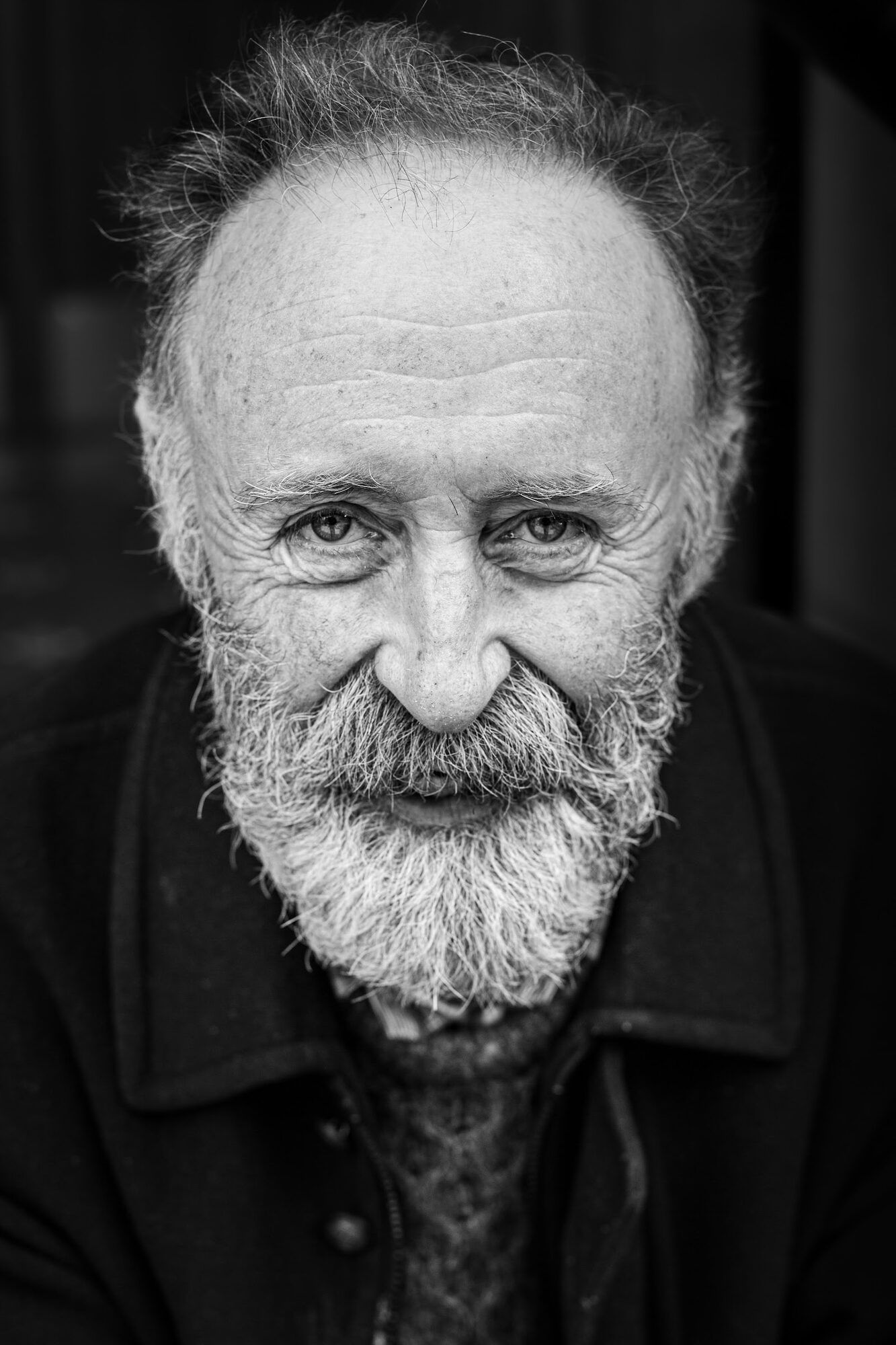 Black-and-white portrait of an older man with a white beard