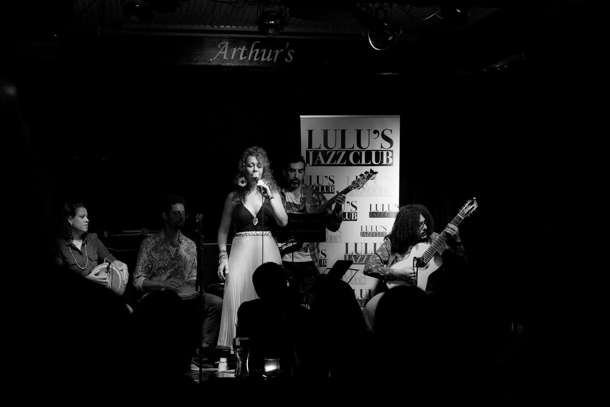 Black and white: a singer and musicians on stage