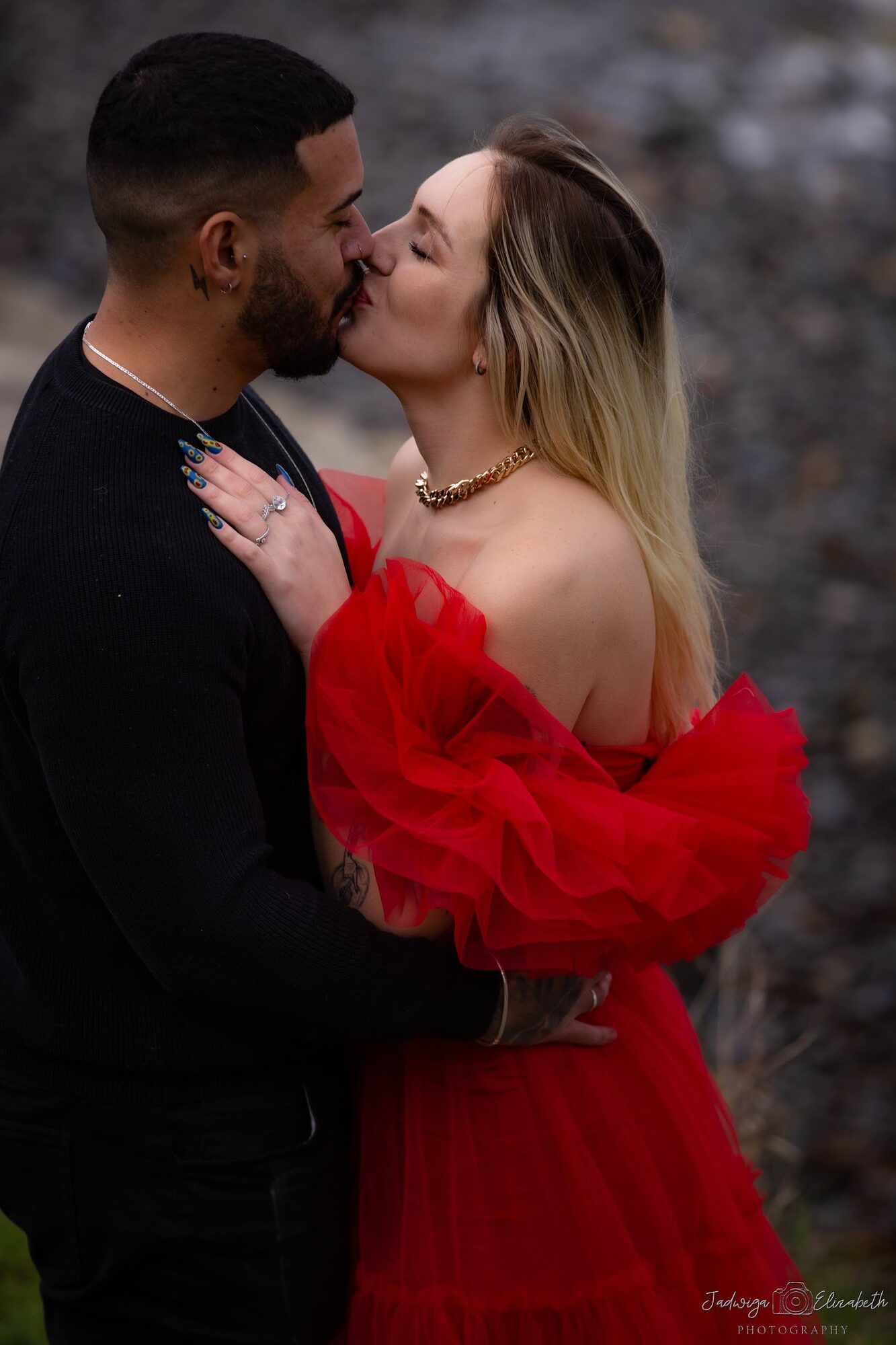 A kiss, the red gown in the foreground