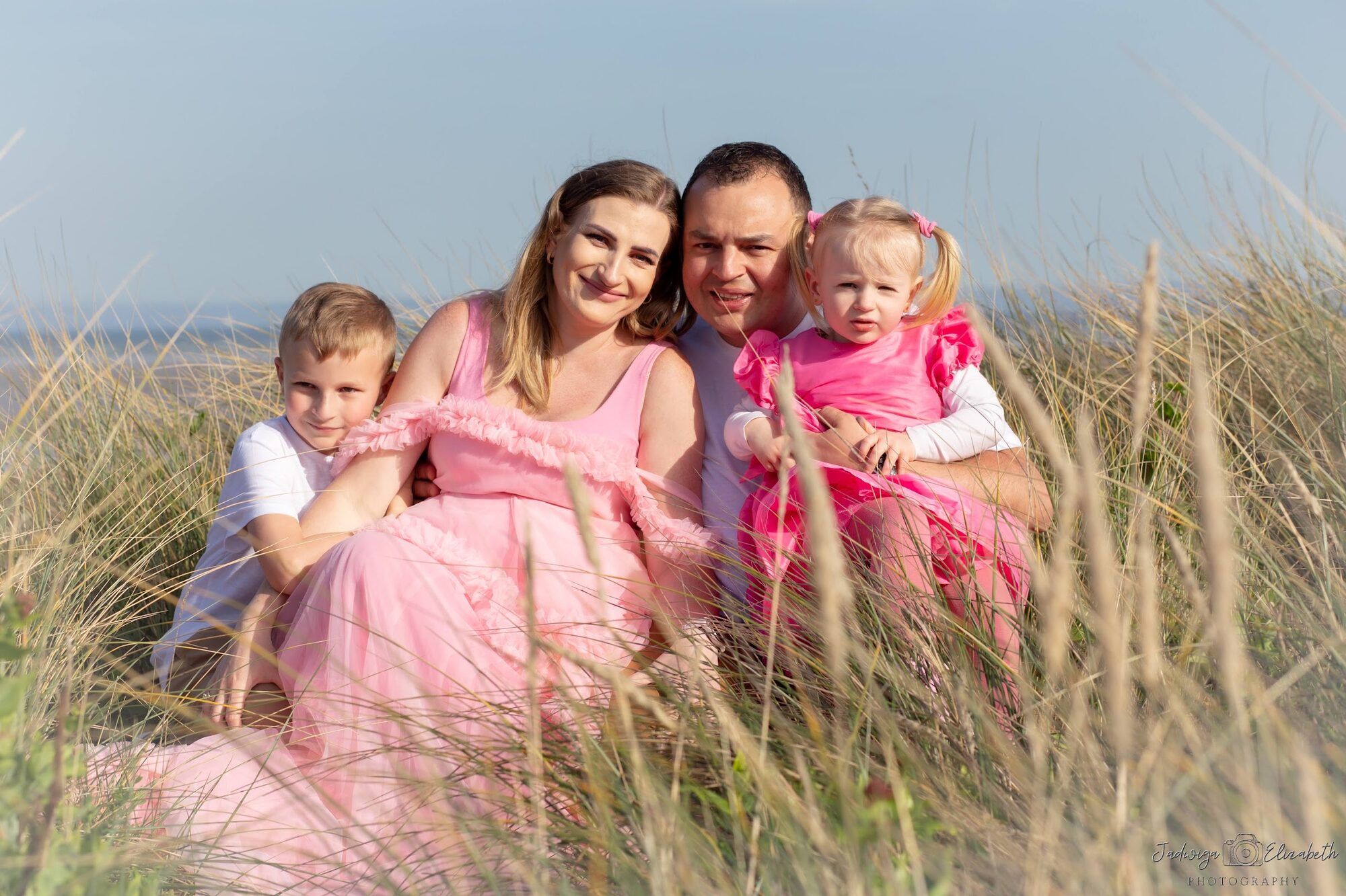Family of four in dune grass