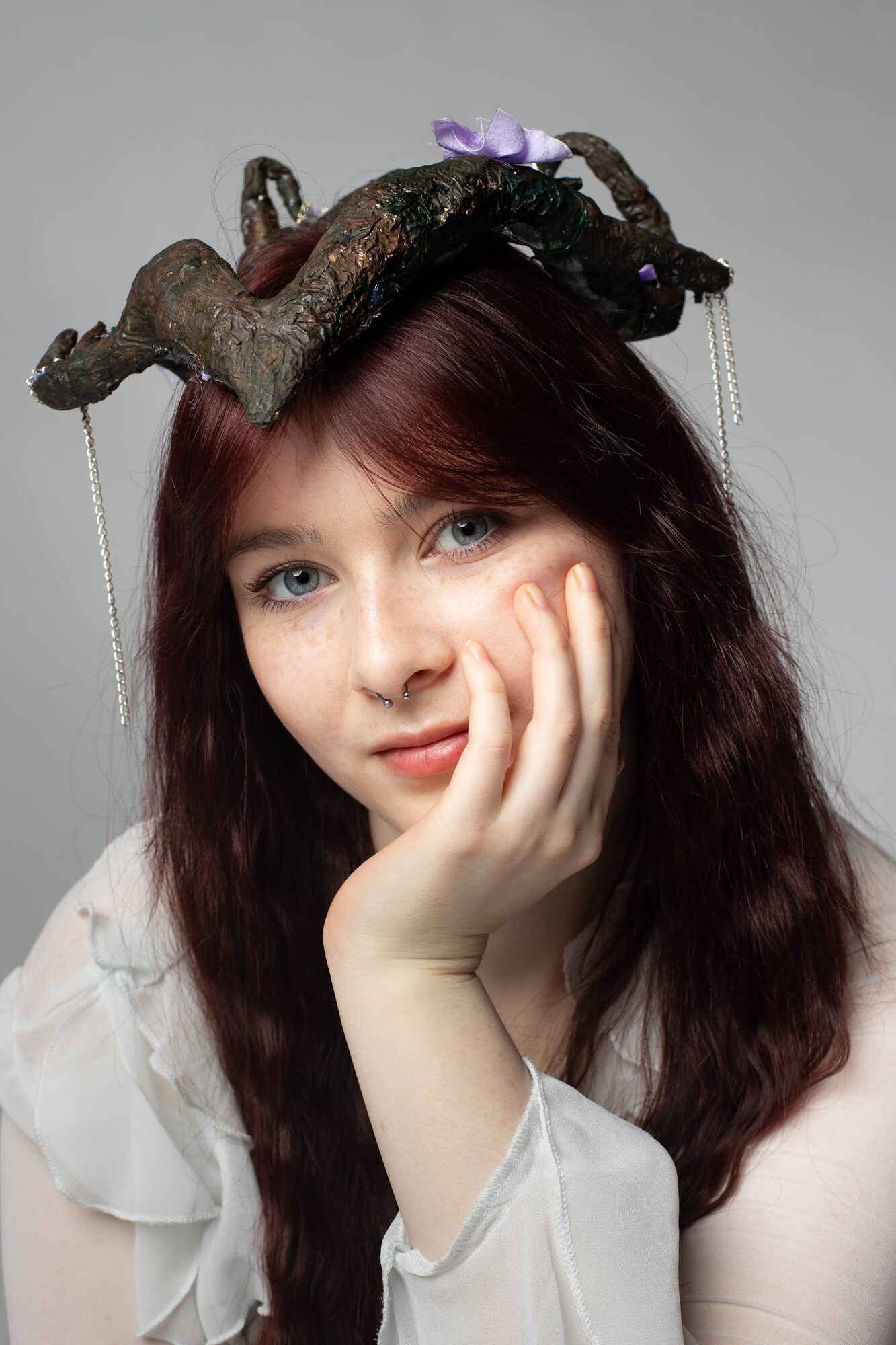 The same young woman closer, hand on her cheek