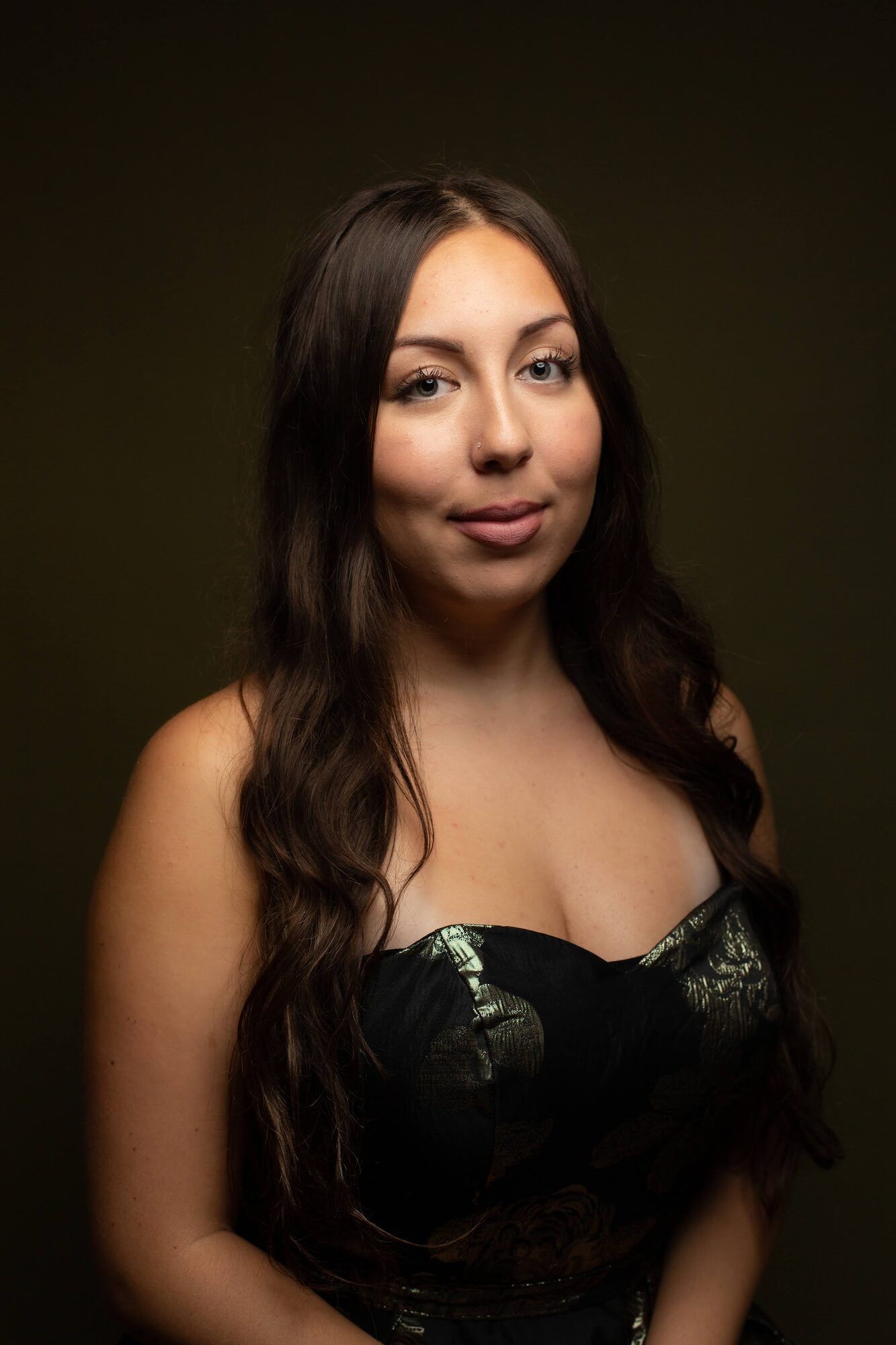 Young woman with long dark hair in a black dress