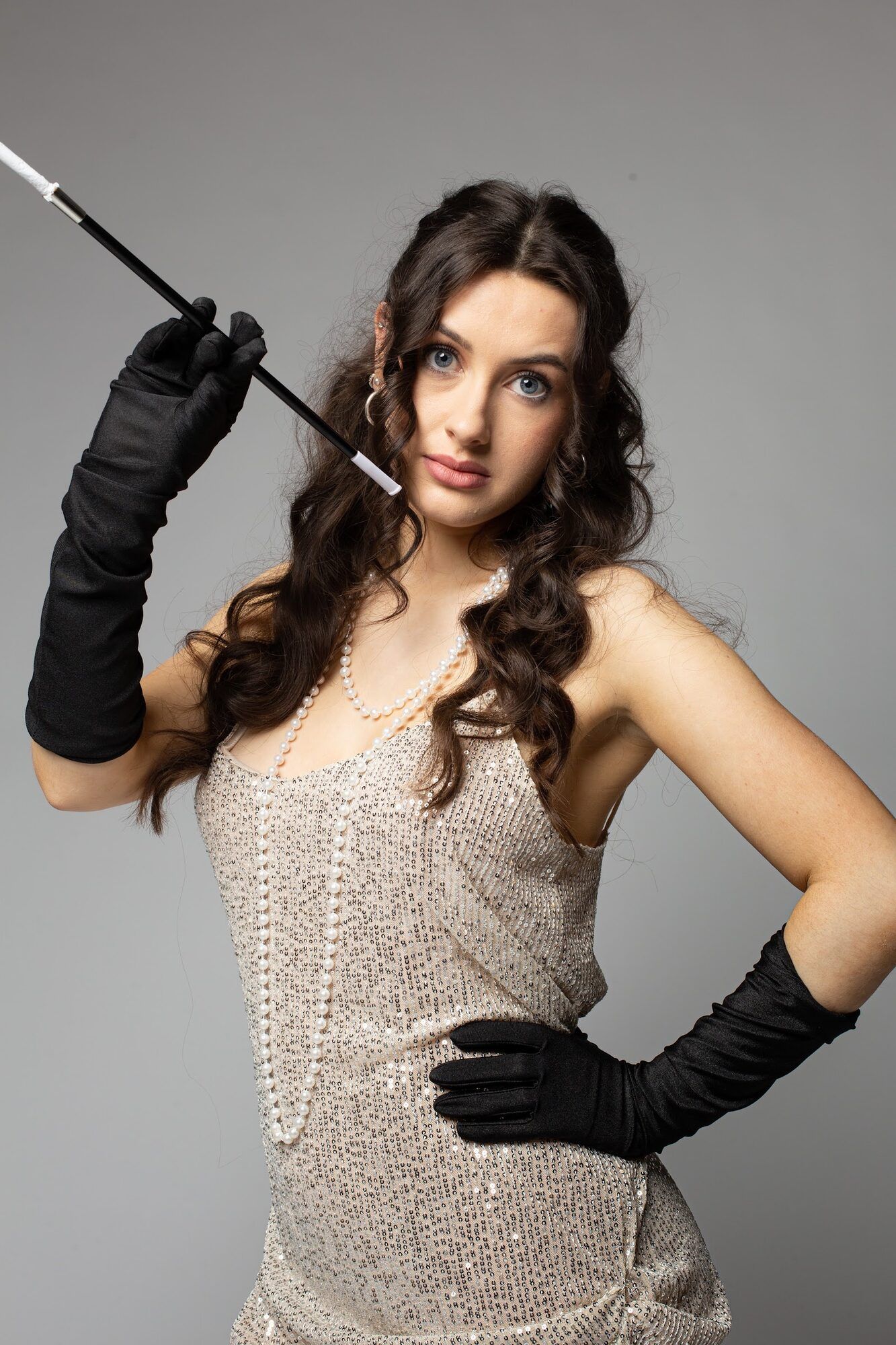 The same woman, cigarette holder raised