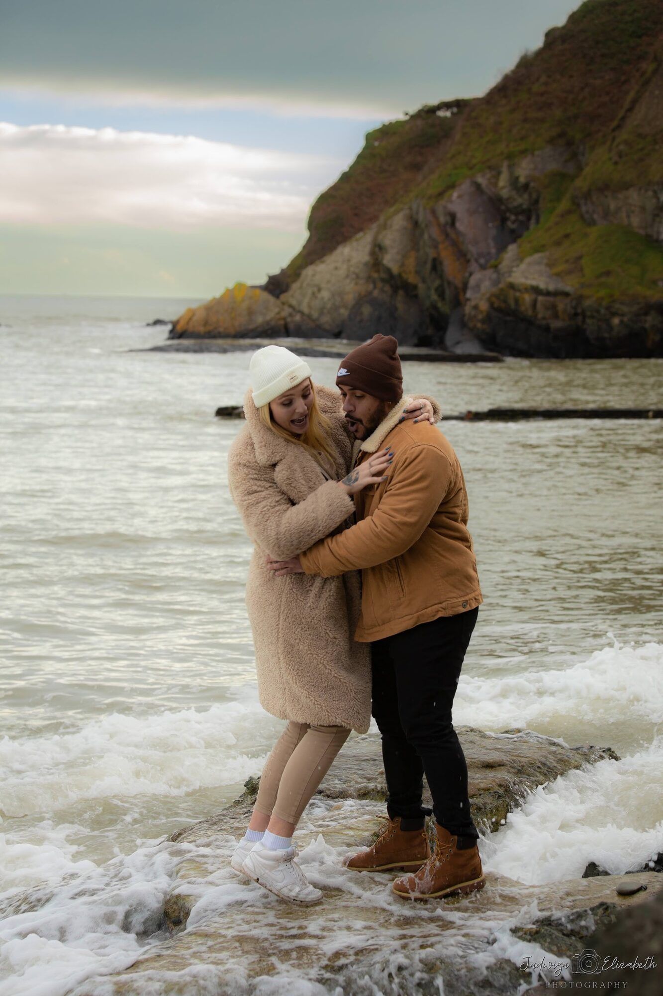 The couple standing in the surf