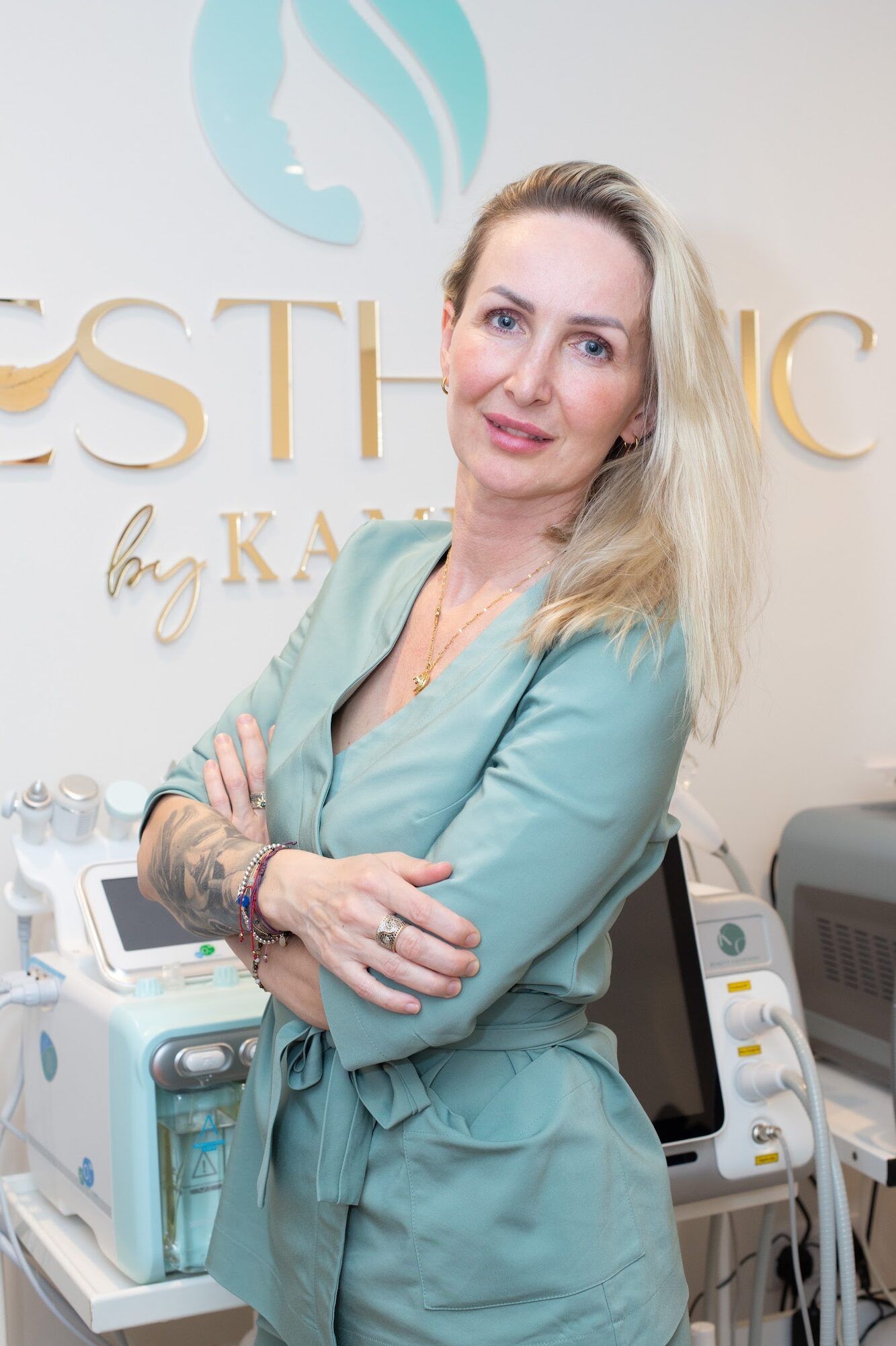 Woman in a teal tunic in her aesthetic clinic