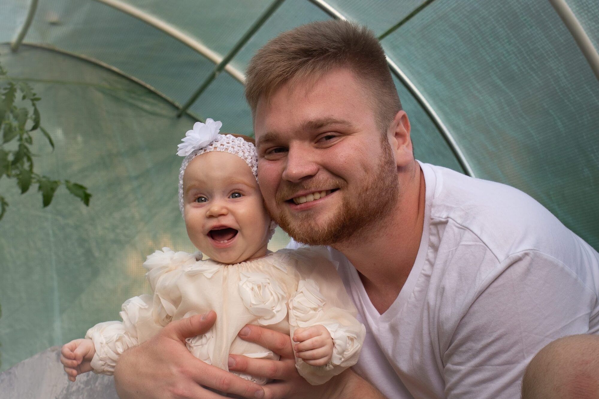 Father and baby daughter smiling