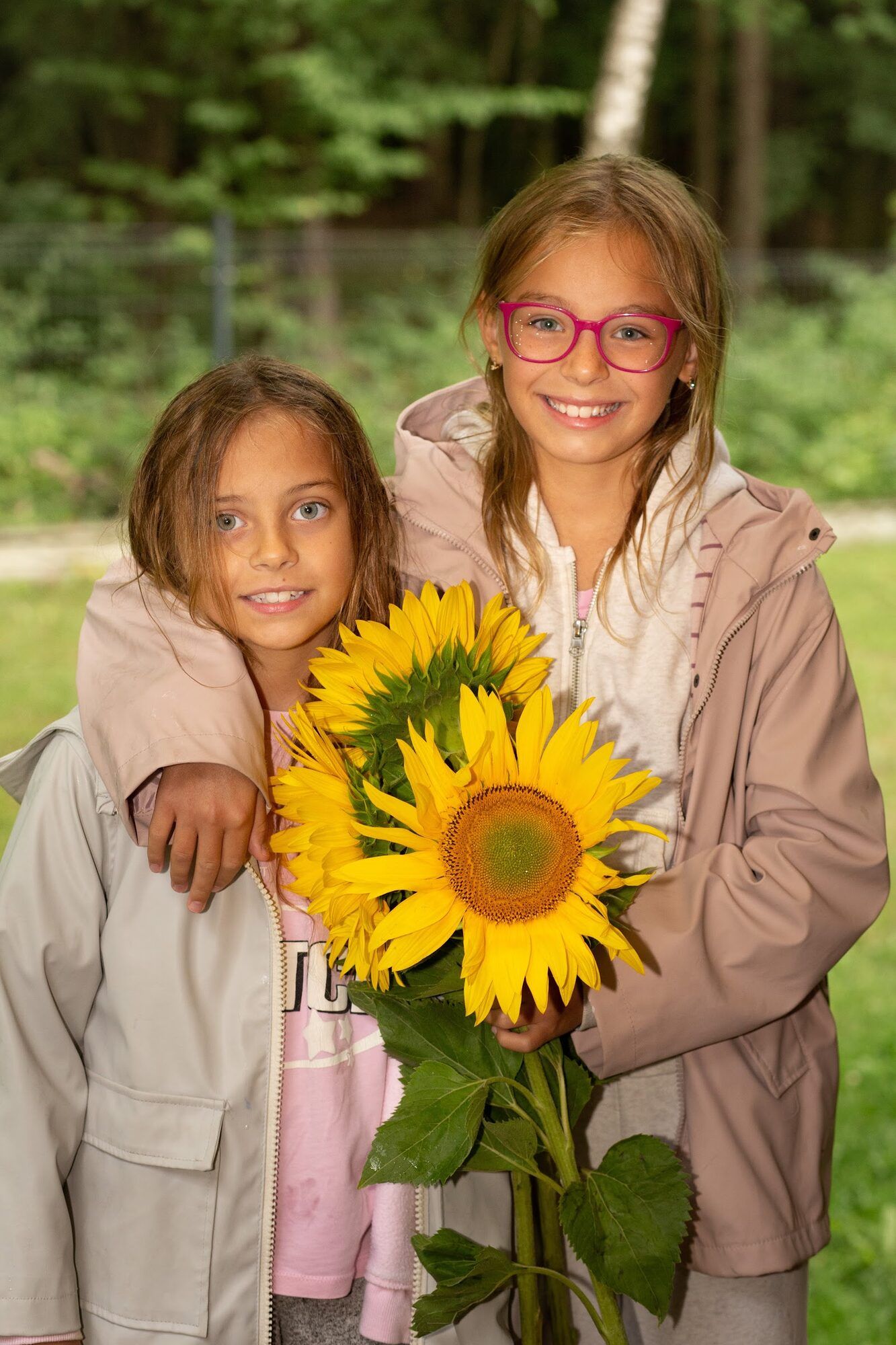 Two girls with a sunflower